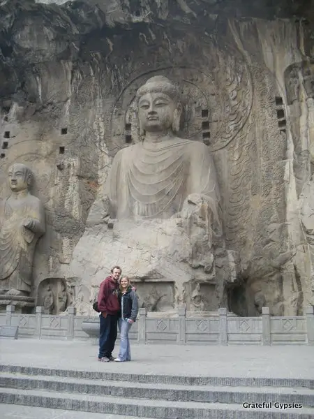 Dwarfed by the massive Buddha carving at the Longmen Grottoes.