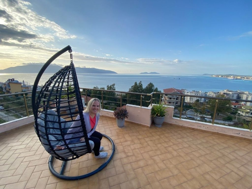 An image of Rachel sitting on the balcony enjoying the sea view in Vlore, Albania